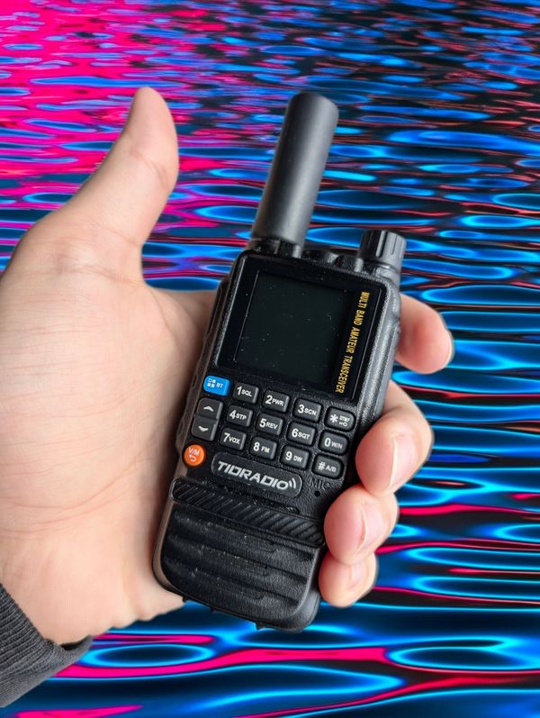 TIDRADIO TD-H3 handheld radio with Airiton stubby antenna, held in hand